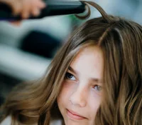 Girl having her hair styled